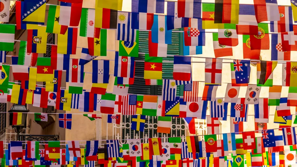 Many different flags hanging on a line