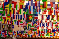 Many different flags hanging on a line