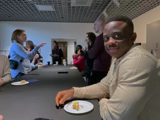 Man with cake at fika table.