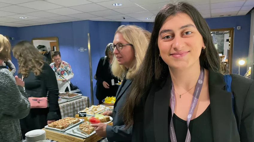 Mariam in front of other participants enjoying "fika".